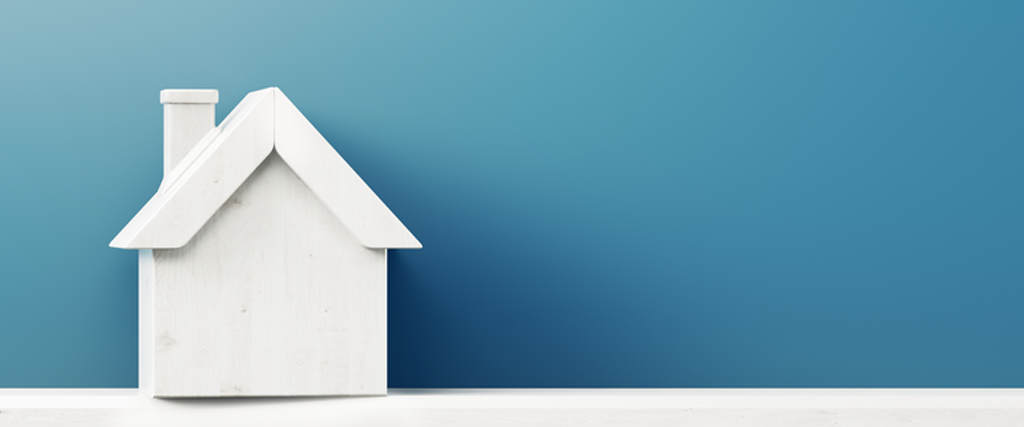 White wooden house with a blue background