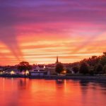 A summer sunset over the city of Janesville WI along the Rock River.