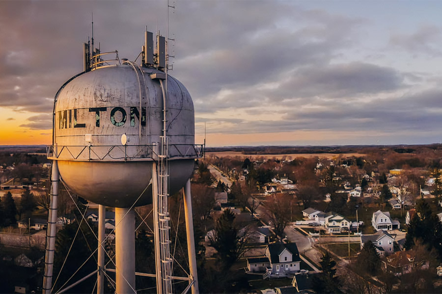 Aerial view of milton wisconsin homes and neighborhoods with the town water tower in the foreground.