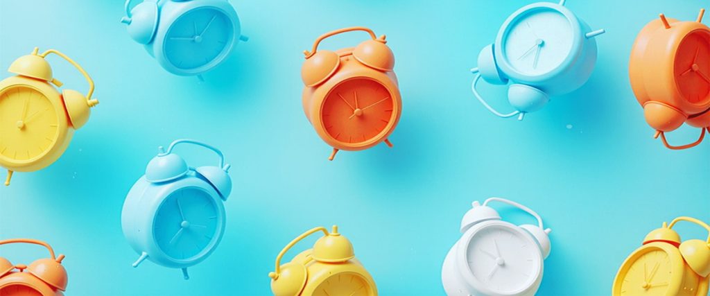 Colorful alarm clocks on a blue background representing the best time to list your house.